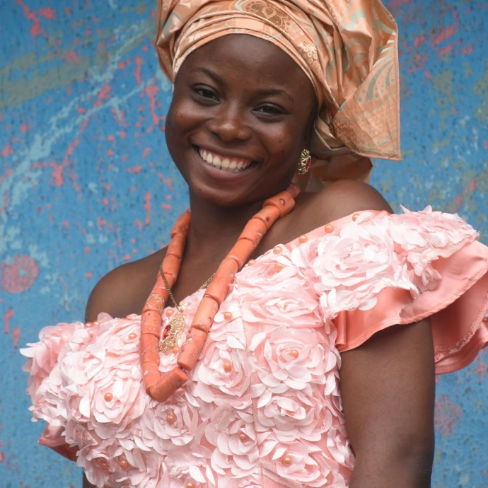 woman in pink and white floral dress smiling